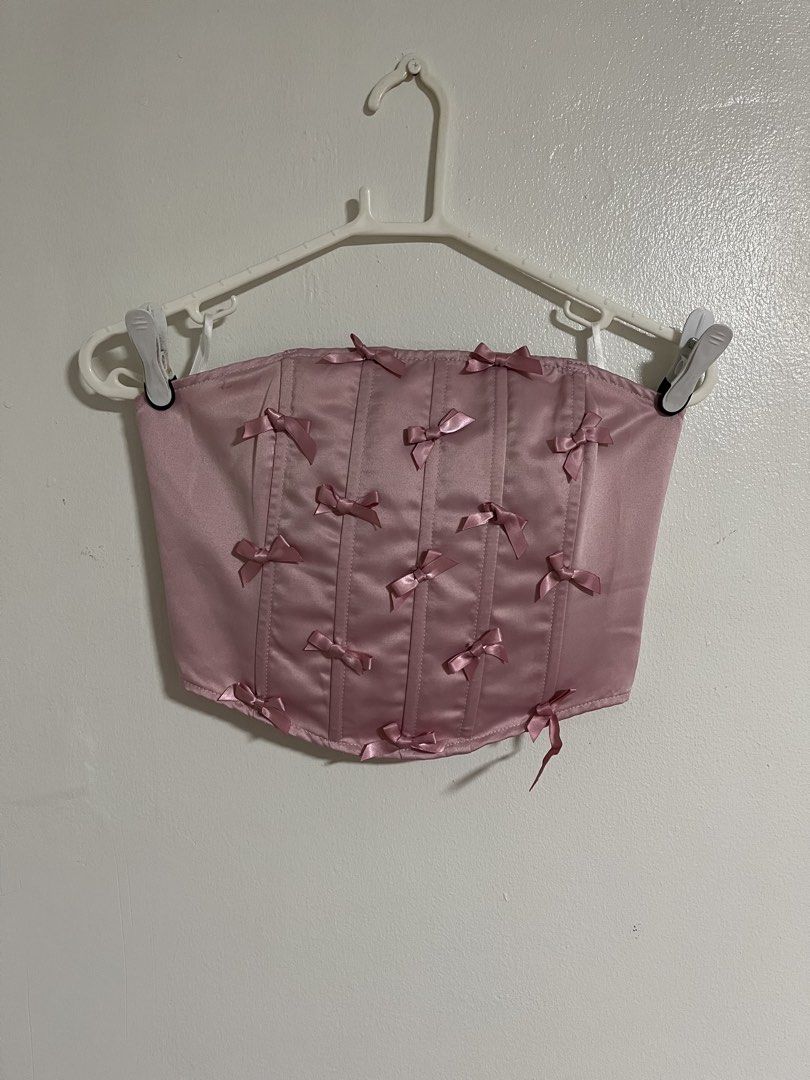 SHEIN Pink Bow Corset Crop Top (Category: Sleeveless) located in Cabuyao City. Submitted by rdtrmt (Listing ID 1470577131, Image 1). Description: - Brand: Shein - Style: Strapless tube corset crop top with boning - Design: Pink satin with all-over little bows - Fit: Smocked elastic back panel for easy stretch - Size: Small (US 4, EU 36) - Material: 100% polyester - Condition: still in good condition.