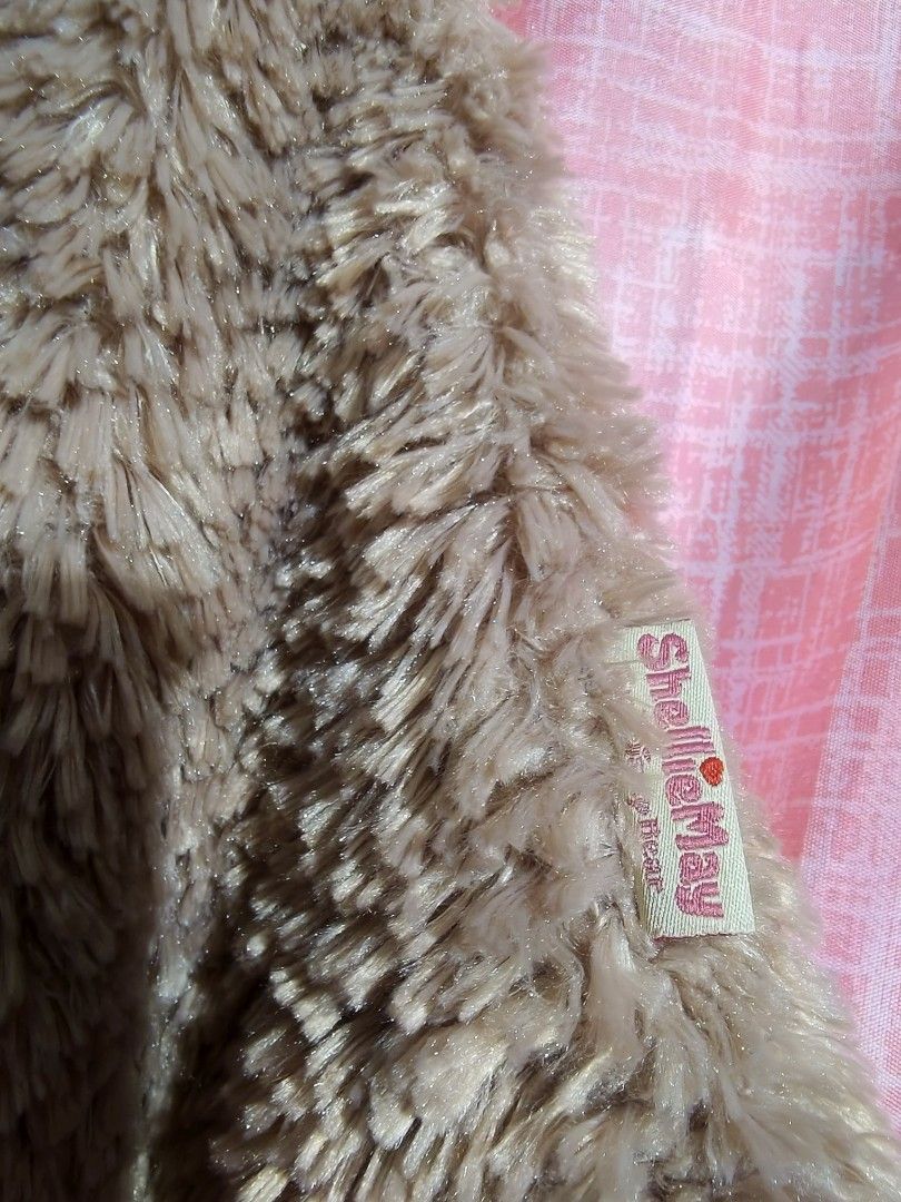 ShellyMay Fuzzy Brown Cape Disney Bear Hooded Jacket (Category: Coats, Jackets and Outerwear) located in Caloocan City. Submitted by mckysprelove (Listing ID 1470564619, Image 2). Description: - Super soft and cozy brown fuzzy cape - Attached hood with embroidered ShellyMay bear face, blue eyes, and pink bow - Embroidered ShellyMay logo patch on the chest - Branded tag attached on the side - Warm fleece material, ideal for Disney trips and theme 