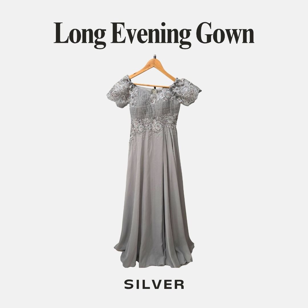 Silver Long Evening Gown Dress Size M (Category: Evening dresses & gowns) located in Guiguinto. Submitted by mariejenna.b (Listing ID 1470575564, Image 1). Description: - Color: Silver - Size: M - Full length: 54 inches - Design: Off-shoulder with short puffy sleeves, pleated bodice, floral embroidery, and sequin waist details - Skirt: Flowy, floor-length chiffon - Ideal for: Weddings, formal dinners, and special occasions RFS: decluttering my cl