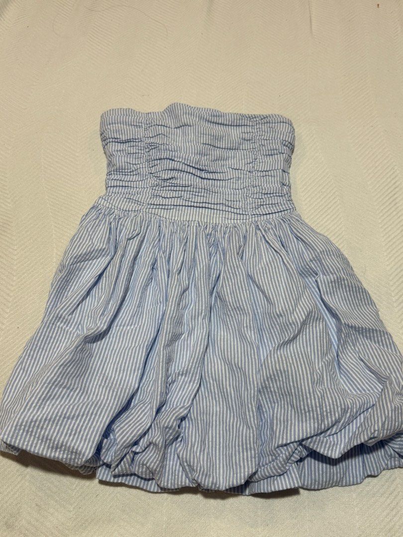 Sincerely Jules Blue White Striped Strapless Bubble Dress (Category: Dresses) located in Pateros City. Submitted by daisy03052000 (Listing ID 1470666716, Image 3). Description: - Brand/Style: Sincerely Jules strapless dress - Color/Pattern: Light blue and white stripes - Size: S (tag attached) - Material: 100% cotton (super lightweight and breathable) - Design details: Smocked bodice with ruching and a fun bubble hem skirt - Condition: Clean and 