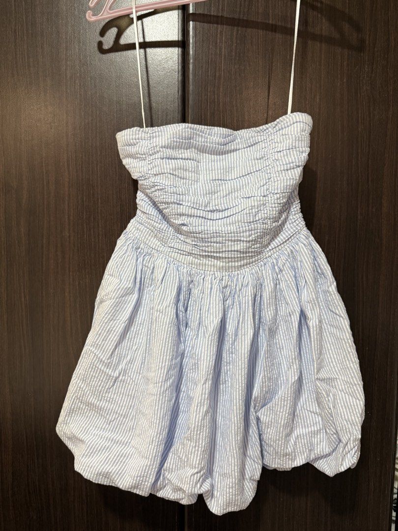 Sincerely Jules Blue White Striped Strapless Bubble Dress (Category: Dresses) located in Pateros City. Submitted by daisy03052000 (Listing ID 1470666716, Image 1). Description: - Brand/Style: Sincerely Jules strapless dress - Color/Pattern: Light blue and white stripes - Size: S (tag attached) - Material: 100% cotton (super lightweight and breathable) - Design details: Smocked bodice with ruching and a fun bubble hem skirt - Condition: Clean and 