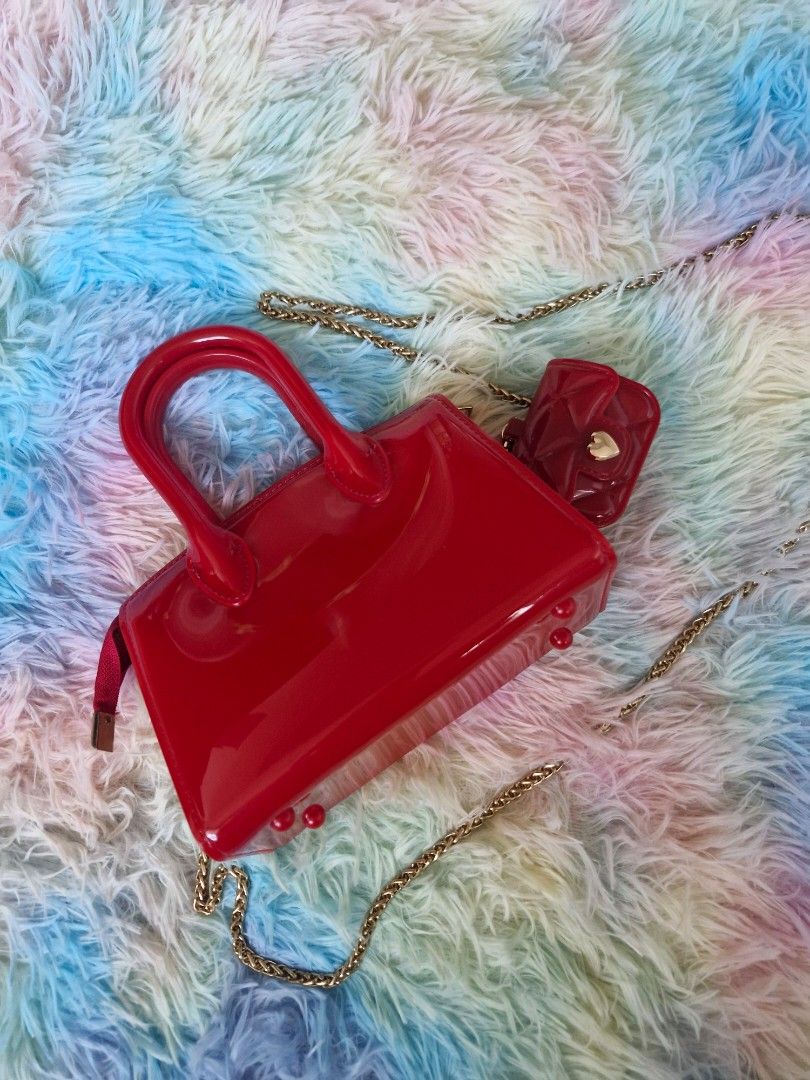 Sling bag like "Melissa product type" (Category: Cross-body Bags) located in Quezon City. Submitted by glenshoppe_ph (Listing ID 1470620475, Image 3). Description: like Brandnew (once used only) Small sling bag color red with combination with gold wear Php 650 📦🛵 thru lalamove or j&t.