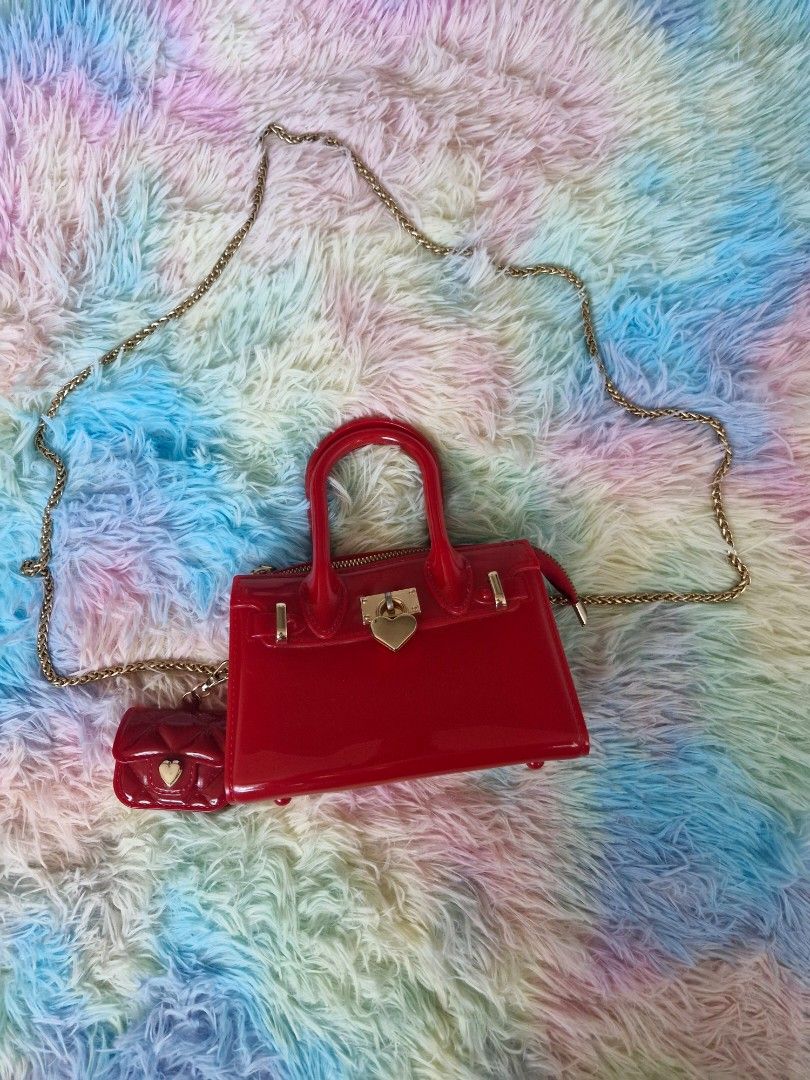 Sling bag like "Melissa product type" (Category: Cross-body Bags) located in Quezon City. Submitted by glenshoppe_ph (Listing ID 1470620475, Image 2). Description: like Brandnew (once used only) Small sling bag color red with combination with gold wear Php 650 📦🛵 thru lalamove or j&t.