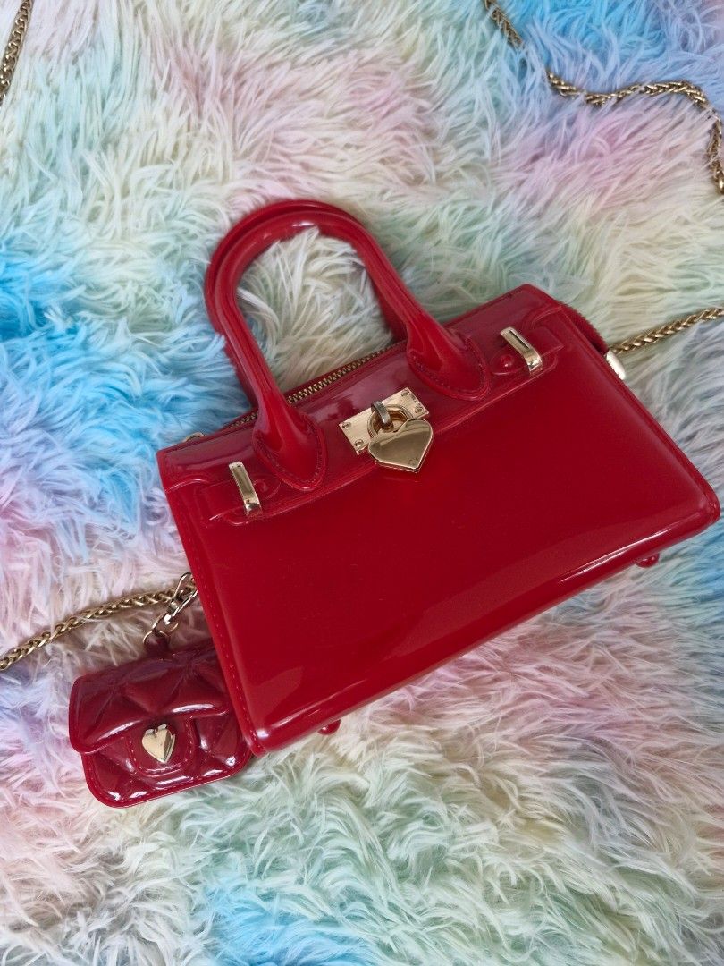 Sling bag like "Melissa product type" (Category: Cross-body Bags) located in Quezon City. Submitted by glenshoppe_ph (Listing ID 1470620475, Image 1). Description: like Brandnew (once used only) Small sling bag color red with combination with gold wear Php 650 📦🛵 thru lalamove or j&t.