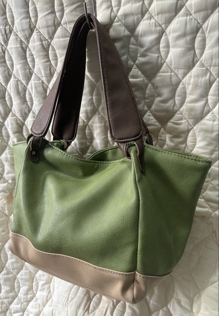 Soft Leather Tote Shoulder Bag from Japan (Category: Tote Bags) located in Santa Rosa. Submitted by esplanamur03635 (Listing ID 1470692672, Image 2). Description: - Color: Green soft leather with brown straps and neutral beige base - Size: Medium, structured shape - Interior: Fully lined with slip pockets and one zipper pocket magnetic lock - Straps: Sturdy handles, comfortable for shoulder wear, lightweight - Condition: Clean inside and out Perf