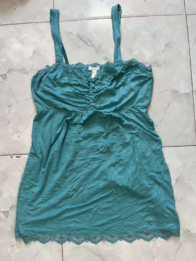 Soma Teal Lace Trim Cami Top (Category: Sleeveless) located in Caloocan City. Submitted by kimronnel (Listing ID 1470578477, Image 1). Description: - Brand: Soma - Size: Large - Color: Teal - Material: 93% Rayon, 7% Spandex - Features: Delicate lace trim on neckline and hem, front ruching with a cute decorative bow, and adjustable straps - Perfect for layering or as a cozy sleepwear piece.