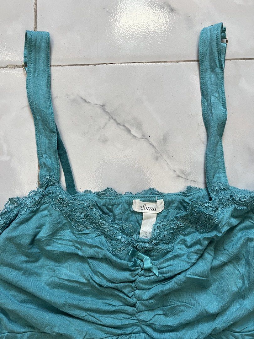 Soma Teal Lace Trim Cami Top (Category: Sleeveless) located in Caloocan City. Submitted by kimronnel (Listing ID 1470578477, Image 2). Description: - Brand: Soma - Size: Large - Color: Teal - Material: 93% Rayon, 7% Spandex - Features: Delicate lace trim on neckline and hem, front ruching with a cute decorative bow, and adjustable straps - Perfect for layering or as a cozy sleepwear piece.