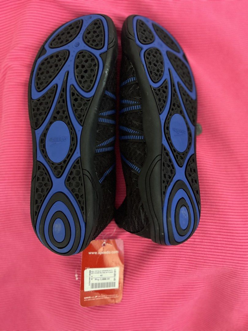 Speedo Water Shoes (Category: Water Sports) located in Manila. Submitted by zellie11 (Listing ID 1470560862, Image 3). Description: - Brand: Speedo - Condition: Brand new with original store tag attached - Color: Black with blue accents and patterned uppers - Closure: Slip-on design with adjustable bungee lace and toggle - Sole: Non-slip blue and black rubber outsole for superior grip on wet surfaces - Ideal for: Swimming, beach trips, water spor