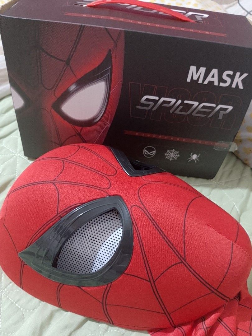Spiderman mask with Eye Movement (Category: Western Merchandise) located in Pasig City. Submitted by sweetchinchin15 (Listing ID 1470574739, Image 2). Description: Spider-Man red fabric mask with black webbing print. Features black rigid eye frames with white mesh lenses. Moving eye mechanism inside controlled by a chin piece. Size is 36x18cm. Includes original packaging box. Elastic material, comfortable to wear for cosplay or parties..
