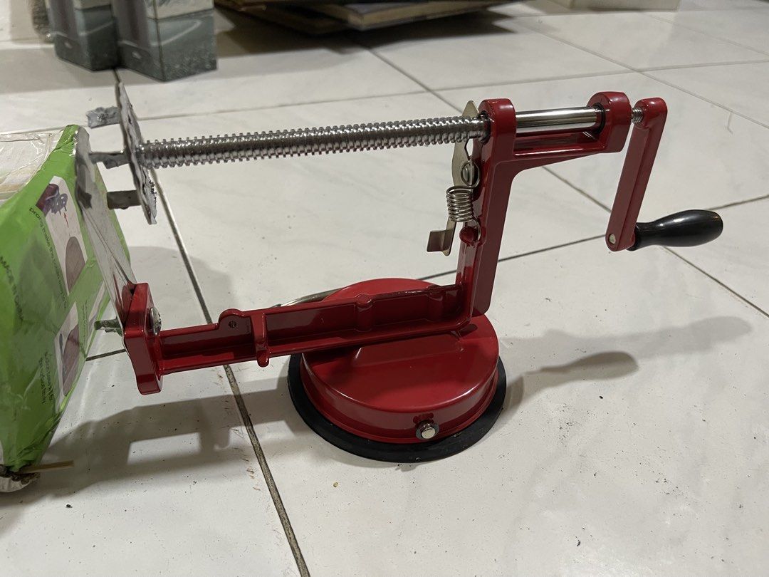 Spiral Potato Slicer Hand Crank Cutter (Category: Cookware & Accessories) located in Pasay City. Submitted by theclutterfree (Listing ID 1470665254, Image 2). Description: new HINDI NAGAMIT - Type: Manual spiral potato slicer - Material: 304 stainless steel blade with durable red metal frame - Base: Sturdy suction base for secure placement - Perfect for making homemade spiral fries and twisted potato chips - Condition: Unit is clean and ready to 
