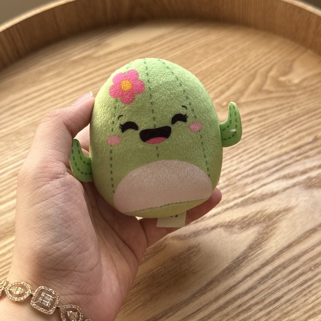 Squishmallows Cactus Plush Toy McDonald's Edition (Category: Plushies & Soft Toys) located in Marikina City. Submitted by lovegoeson (Listing ID 1470725077, Image 2). Description: - Official McDonald's promotional plush toy by Jazwares - Adorable green cactus design with a pink flower and cute arms - Made with soft fabric and detailed stitching - Condition: Clean, excellent, and with no damage - Care: Surface clean only.