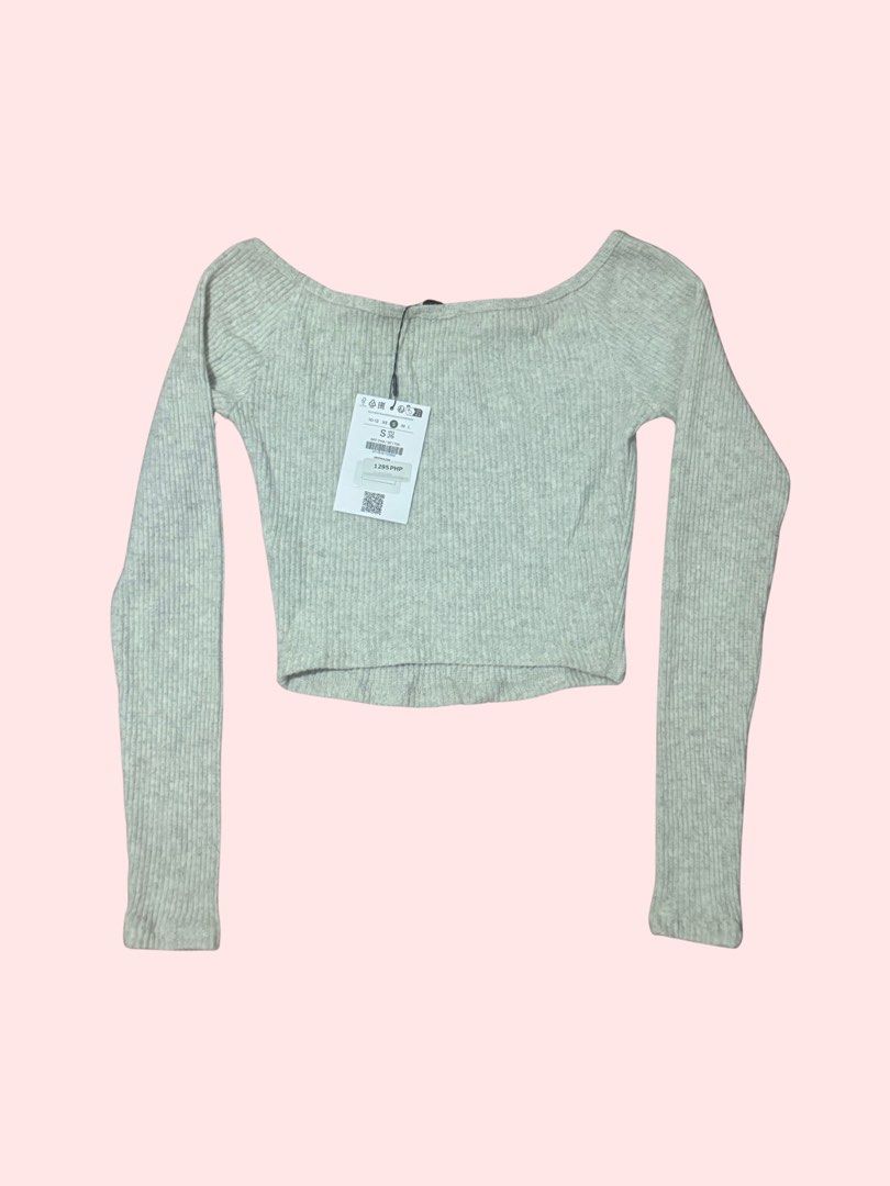 Star Patch Off-Shoulder Crop Top (Category: Longsleeves) located in Pasig City. Submitted by kia.sell (Listing ID 1470576522, Image 2). Description: - Brand: Bershka - Style: Long-sleeve off-shoulder ribbed knit crop top - Color: Heather Light Gray / Mint Off-White - Design Details: Star patch on the chest, elasticized scoop/off-shoulder neckline, fine-ribbed stretch fabric. - Condition: Brand New with Tags (NWT / Pristine, never worn) - Size: S 