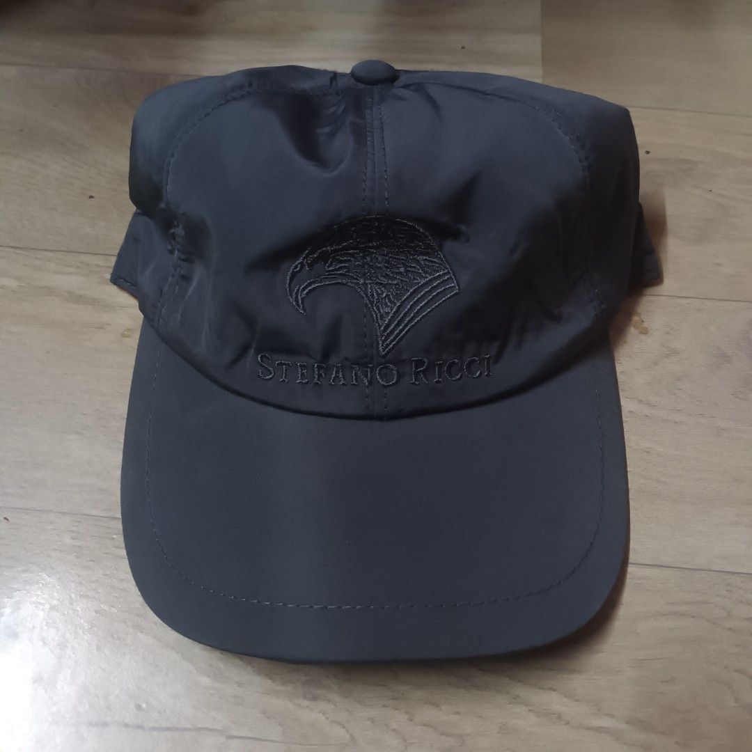 Stefano Ricci Grey Cap (Category: Caps & Hats) located in Manila. Submitted by itsnik444 (Listing ID 1470634783, Image 1). Description: - Brand: Stefano Ricci - Color: Dark grey with grey heather lining and orange inner trim - Design: Embroidered eagle logo and brand name on the front - Fit: Adjustable elastic back strap for a secure fit - Origin: Made in Italy - Care: Machine washable.