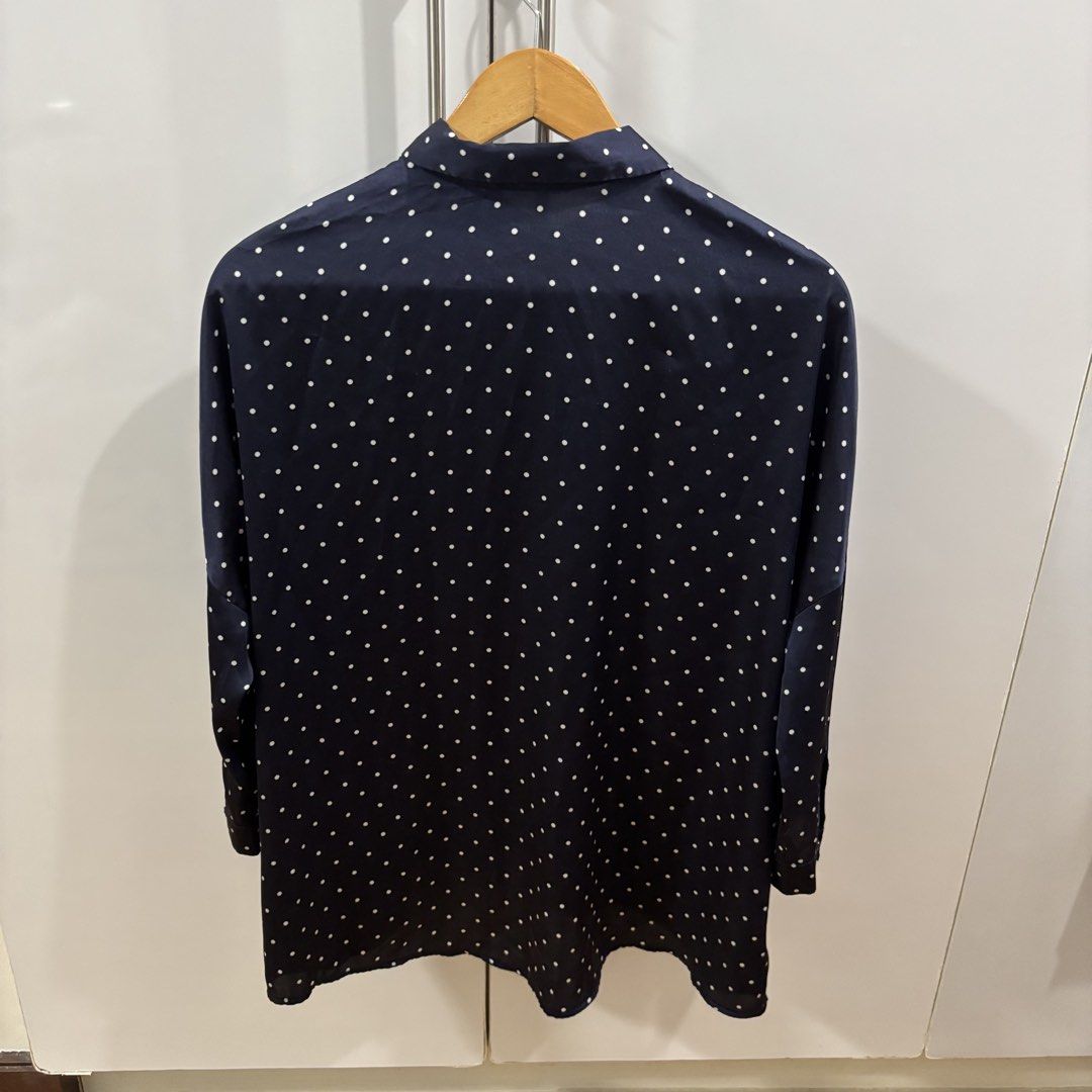 Stradivarius Navy Blue Polka Dot Long Sleeve Button-Down Shirt (Category: Longsleeves) located in Makati City. Submitted by trustmebuythis (Listing ID 1470713263, Image 2). Description: - Color & Pattern: Navy blue with all-over white polka dots - Fit: Relaxed, slightly oversized with a curved hem - Material: Smooth, super soft satin-like fabric - Details: Classic collar, long sleeves, and front button closure - Size: Medium (EUR, USA, and MEX si