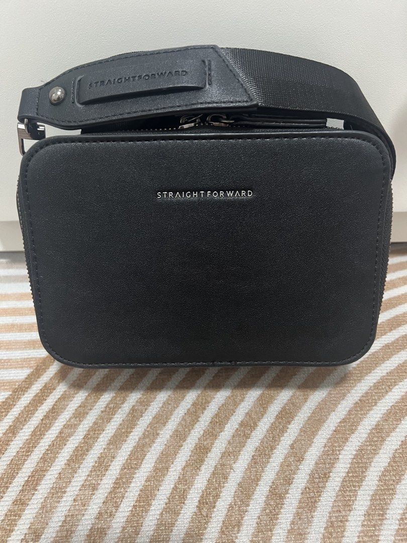 Straightforward Black Sling Bag with Strap (Category: Sling Bags) located in Manila. Submitted by luckymike059973 (Listing ID 1470562960, Image 1). Description: - Brand: Straightforward - Style: Black camera-style sling bag - Details: Branded silver lettering on the front - Storage: Main zip compartment and quick-access back slip pocket for cards - Strap: Thick adjustable strap with printed logo detail on the shoulder pad - Condition: Clean inter