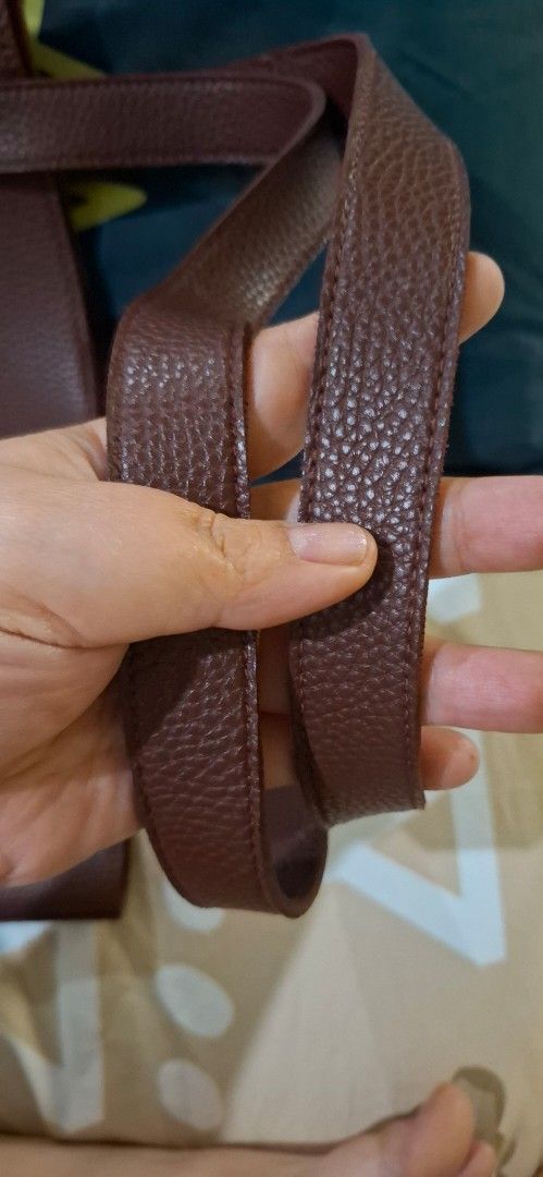Straightforward Brown Leather Tote Bag (Category: Tote Bags) located in Paranaque City. Submitted by finders_thriftersph (Listing ID 1470675180, Image 3). Description: - Material: Premium brown pebbled leather with deep maroon suede interior - Straps: Comfortable dual shoulder straps with clean stitching - Closure: Secure magnetic main snap closure - Storage: Convenient inner pocket with magnetic button closure - Style: Simple, structured design 