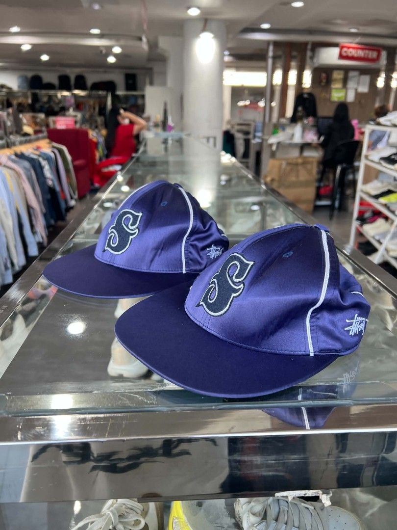 Stüssy Navy Blue Satin Baseball Cap S (Category: Caps & Hats) located in Urdaneta. Submitted by jayceegarage (Listing ID 1470691365, Image 2). Description: - Brand: Stüssy - Style: Satin baseball cap with contrast white piping - Color: Navy blue with embroidered 'S' logo on the front - Size: S (features adjustable back strap for custom fit) - Material: 100% polyester, made in Bangladesh - Stock: 2 identical pieces available (perfect for matching 