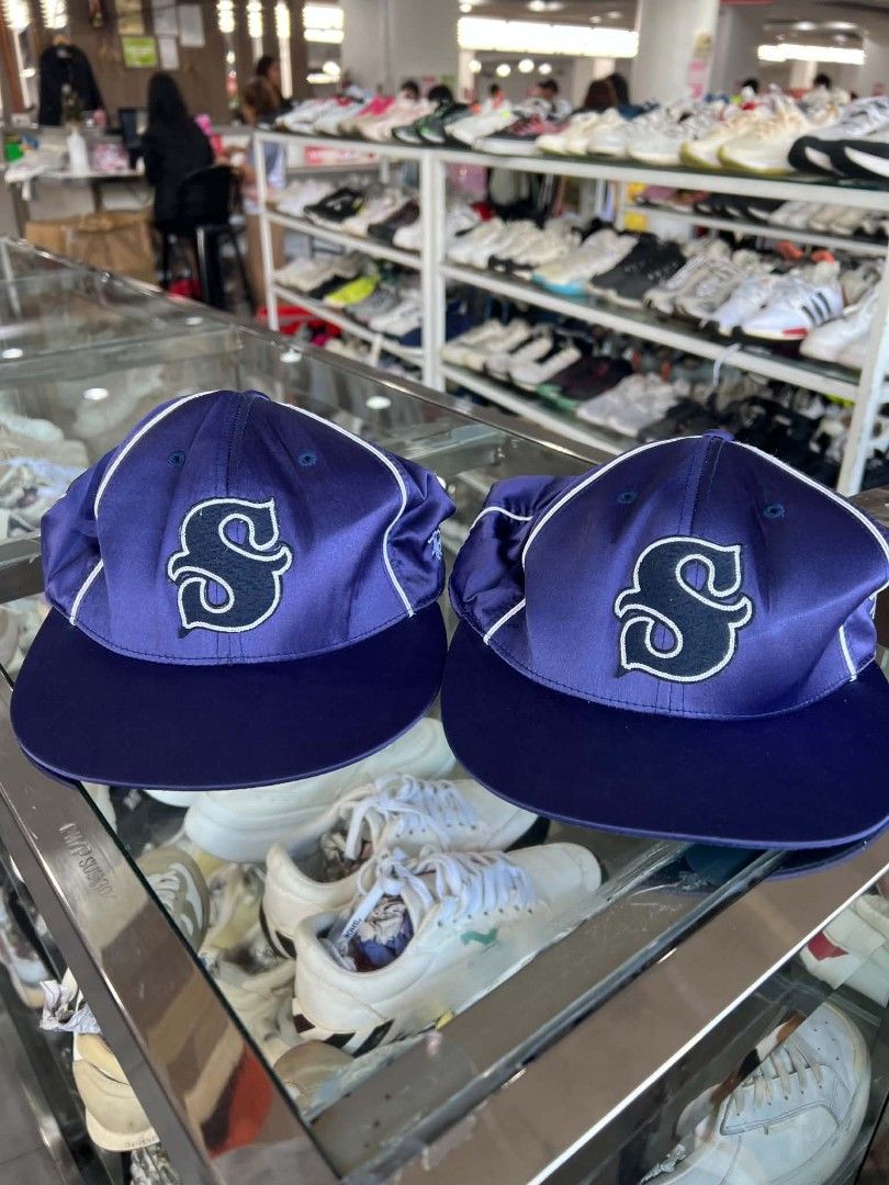 Stüssy Navy Blue Satin Baseball Cap S (Category: Caps & Hats) located in Urdaneta. Submitted by jayceegarage (Listing ID 1470691365, Image 1). Description: - Brand: Stüssy - Style: Satin baseball cap with contrast white piping - Color: Navy blue with embroidered 'S' logo on the front - Size: S (features adjustable back strap for custom fit) - Material: 100% polyester, made in Bangladesh - Stock: 2 identical pieces available (perfect for matching 