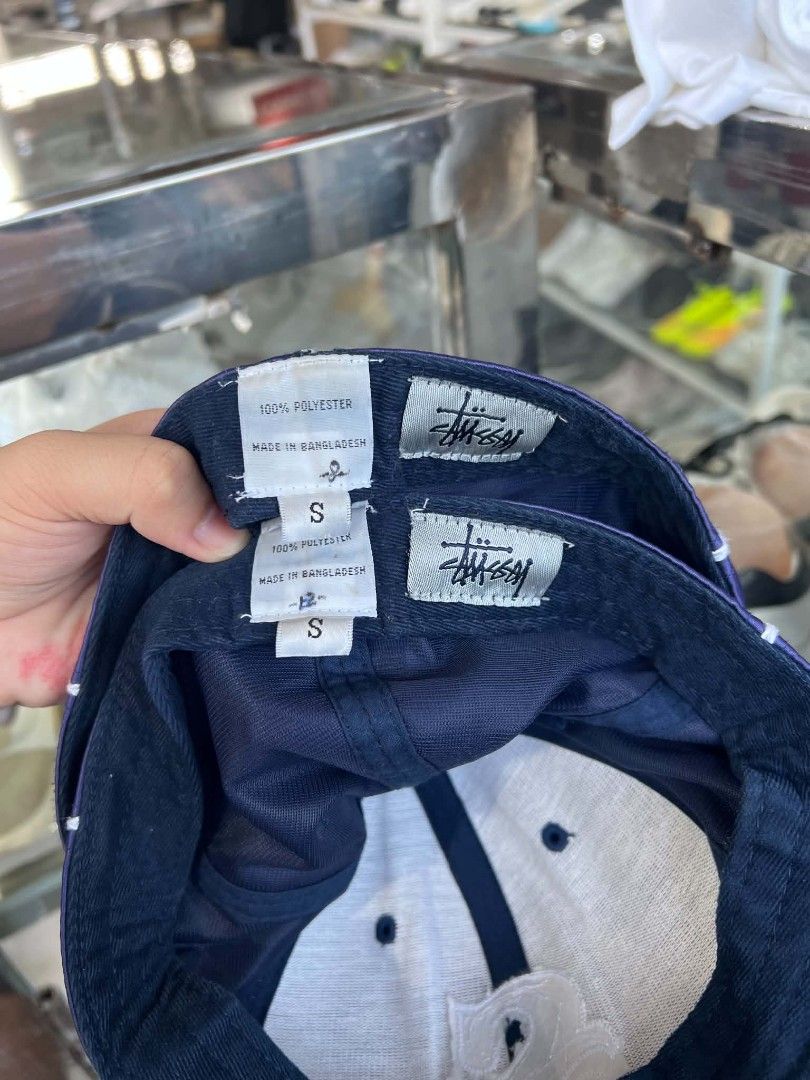 Stüssy Navy Blue Satin Baseball Cap S (Category: Caps & Hats) located in Urdaneta. Submitted by jayceegarage (Listing ID 1470691365, Image 3). Description: - Brand: Stüssy - Style: Satin baseball cap with contrast white piping - Color: Navy blue with embroidered 'S' logo on the front - Size: S (features adjustable back strap for custom fit) - Material: 100% polyester, made in Bangladesh - Stock: 2 identical pieces available (perfect for matching 