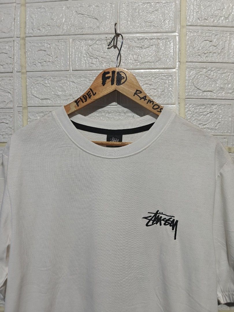 Stussy 8 Ball Angel White Tee (Category: Tshirts & Polo Shirts ) located in Manila. Submitted by fideldelrosario1 (Listing ID 1470637129, Image 3). Description: 22BY28 - Brand: Stussy - Color: Crisp white - Size: MEDIUM - Design: Small chest logo with large winged 8-ball graphic on the back - Fit: Standard fit with crew neck and black inner collar tape - Condition: Excellent, clean with no stains or holes - Shipping: Ships fast from the Philippin