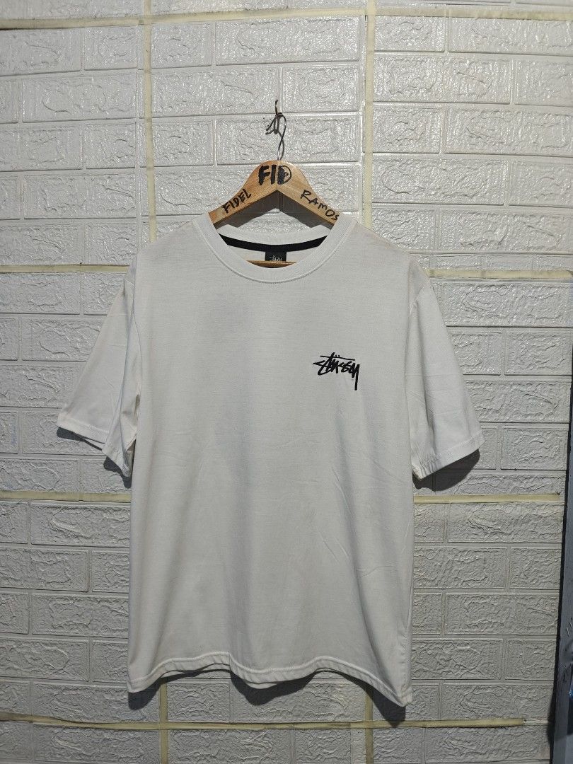 Stussy 8 Ball Angel White Tee (Category: Tshirts & Polo Shirts ) located in Manila. Submitted by fideldelrosario1 (Listing ID 1470637129, Image 2). Description: 22BY28 - Brand: Stussy - Color: Crisp white - Size: MEDIUM - Design: Small chest logo with large winged 8-ball graphic on the back - Fit: Standard fit with crew neck and black inner collar tape - Condition: Excellent, clean with no stains or holes - Shipping: Ships fast from the Philippin