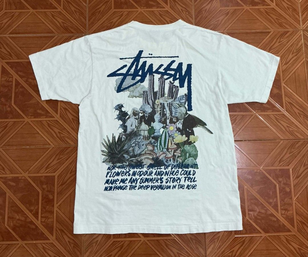 Stussy Graphic Tee White (Category: Tshirts & Polo Shirts ) located in Manila. Submitted by janbrix (Listing ID 1470605848, Image 2). Description: - Brand: Stussy - Color: Classic White - Fit: Regular fit, standard streetwear tee - Design: Small front chest pocket print & large surreal back collage graphic (cacti, birds, flowers, typography) - Details: Short sleeves, crew neck - Condition: Excellent pre-loved condition - Shipping: Ships fast from