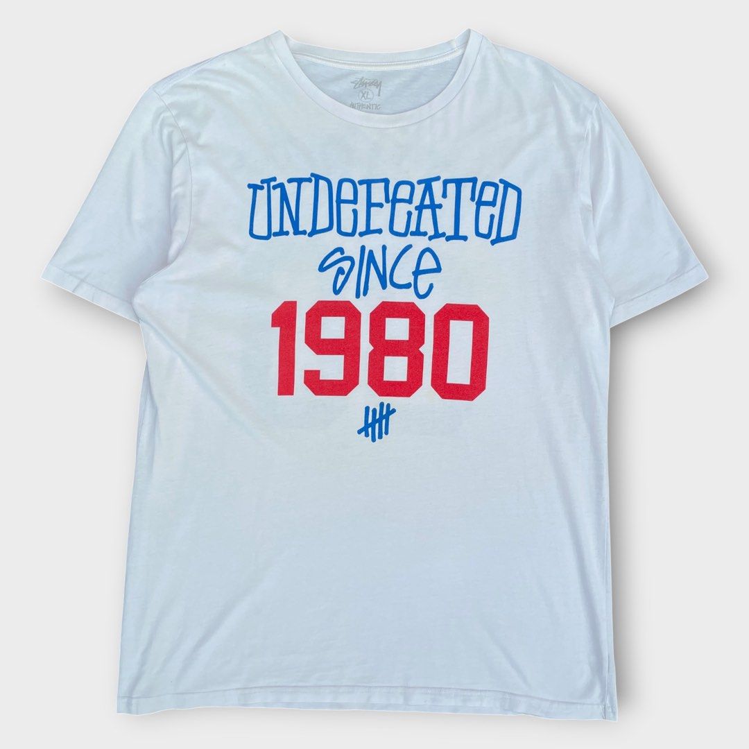 Stussy x Undefeated - 30th Anniversary Tee (Category: Tshirts & Polo Shirts ) located in Los Banos. Submitted by declutterking (Listing ID 1470661615, Image 1). Description: Size XL on tag (fits M-L) Stussy partners with another roster of impressive brands for the group 3 release. The third run of partners involves American giant Undefeated, Commonwealth, Canadian heavy weight Ransom, the ever vivid Cassette Playa, the emblematic CLOT, NEXUSVII, 