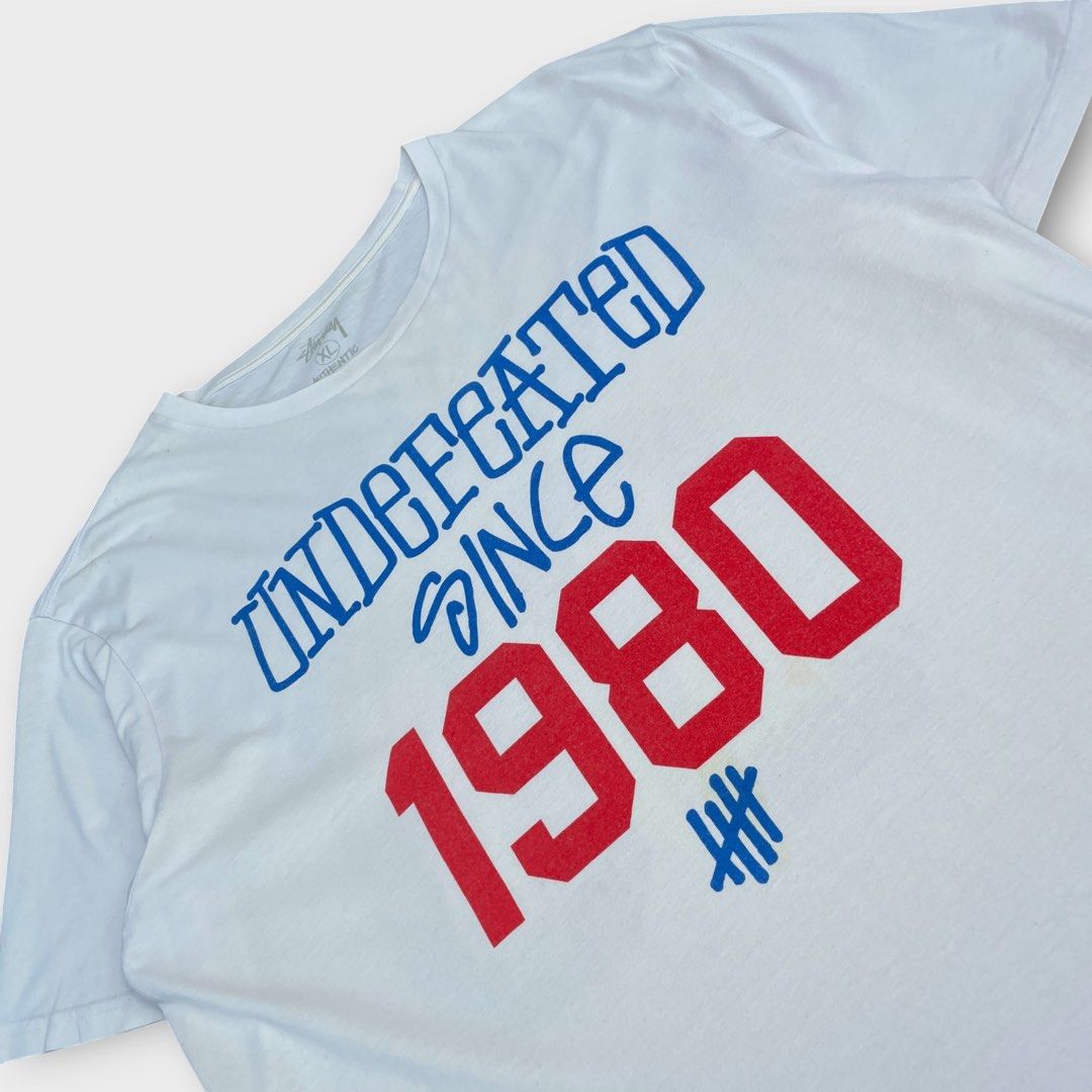 Stussy x Undefeated - 30th Anniversary Tee (Category: Tshirts & Polo Shirts ) located in Los Banos. Submitted by declutterking (Listing ID 1470661615, Image 2). Description: Size XL on tag (fits M-L) Stussy partners with another roster of impressive brands for the group 3 release. The third run of partners involves American giant Undefeated, Commonwealth, Canadian heavy weight Ransom, the ever vivid Cassette Playa, the emblematic CLOT, NEXUSVII, 