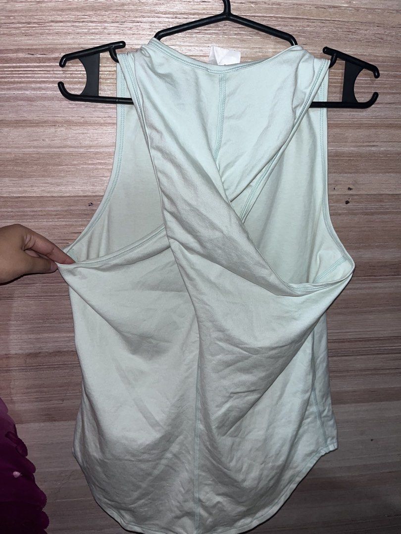 Sung , Addiddas and Preloved Tops (Category: Activewear) located in Manila. Submitted by fastflower.4b5f11 (Listing ID 1470741194, Image 3). Description: Athletic tank top from Sung in a pale green shade. Size small on the tag. Racerback design with a twisted cross back detail. Soft fabric blend of 89% polyester and 11% spandex, made in the USA. Curved hemline with a small logo tag near the bottom. Great piece for workouts or casual activewear da