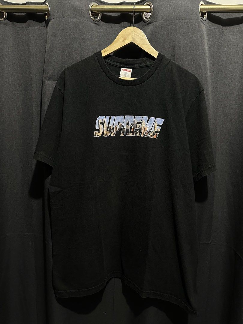 Supreme City Skyline / Collage Box Logo Graphic Tee (Category: Tshirts & Polo Shirts ) located in Buenavista. Submitted by themodernrack (Listing ID 1470591455, Image 1). Description: Condition: Good condition, minimal hairline wear Measurements & Sizing: Size: Tagged Size L Width (Pit to Pit): 22” Length: 29”.