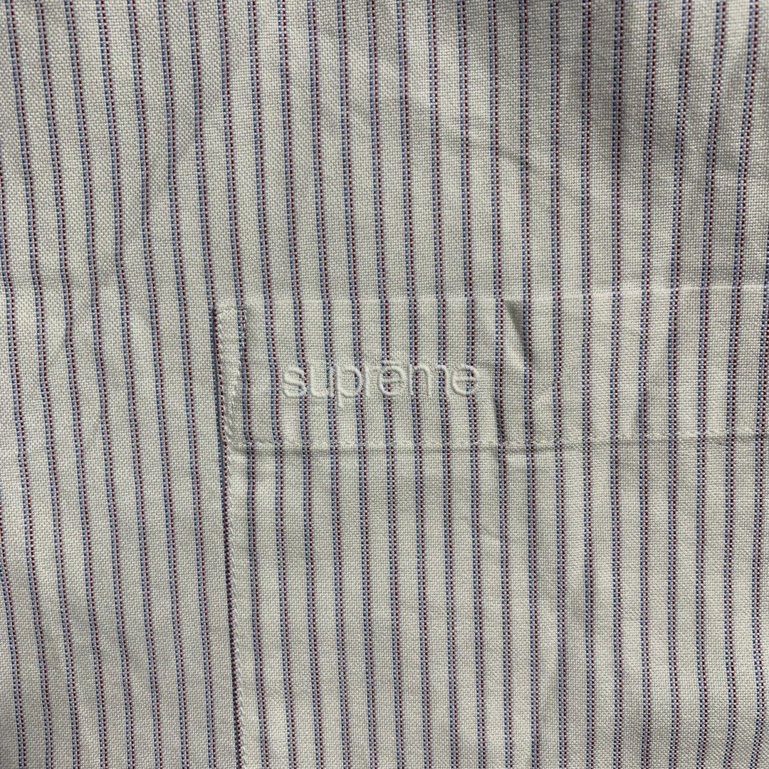 Supreme Striped Short Sleeve Button Down Shirt Size L (Category: Luxury Apparel) located in Dagupan City. Submitted by source_ph (Listing ID 1470685224, Image 3). Description: Size: XL mens ‎Width : 28 ‎Length: 33 ‎Shoulder: 22 ‎Sleeves: 12 - Brand: Supreme - Style: Short sleeve button-down shirt - Color/Pattern: White base with fine blue and red vertical stripes - Details: Button-down collar, front chest pocket with embroidered Supreme logo, red
