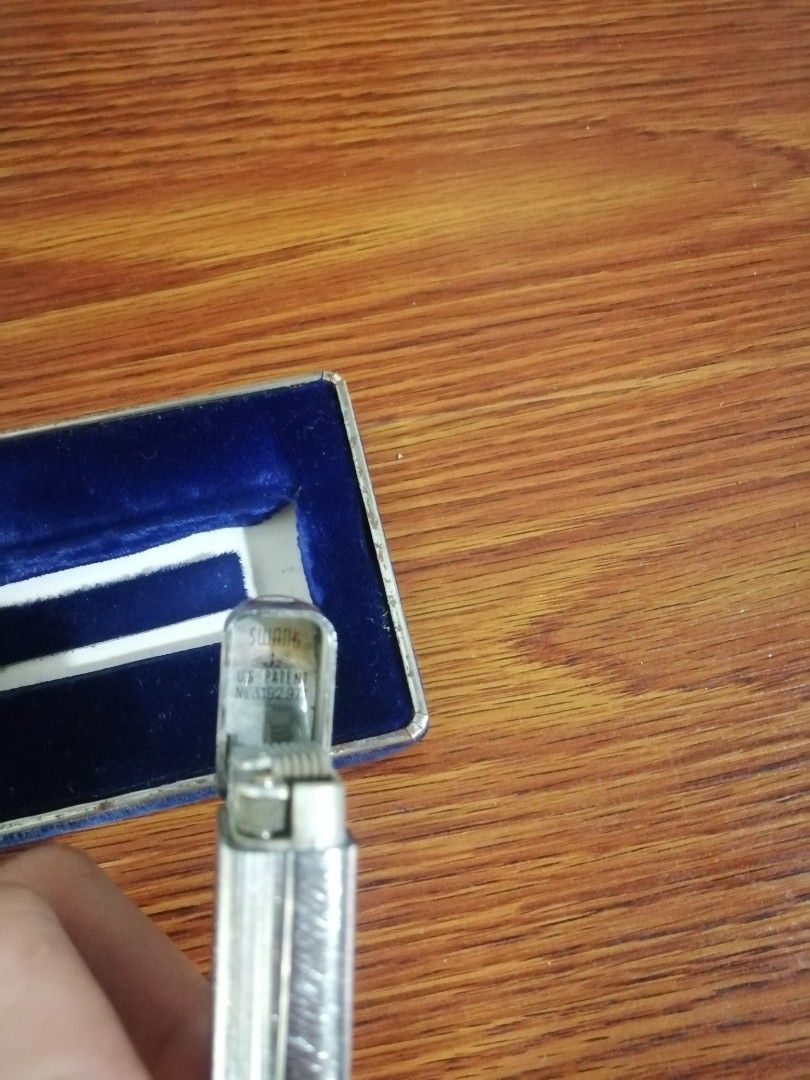 SWANK Cutlass Butane Lighter in Original Box as is (Category: Vintage Collectibles) located in Caloocan City. Submitted by jeicee858582831 (Listing ID 1470595123, Image 2). Description: - Vintage SWANK Cutlass butane lighter - Silver-tone textured finish body - Engraved with SWANK and U.S. Patent No. 319297 - Comes with original dark blue presentation box and cream satin lining - Excellent find for collectors.