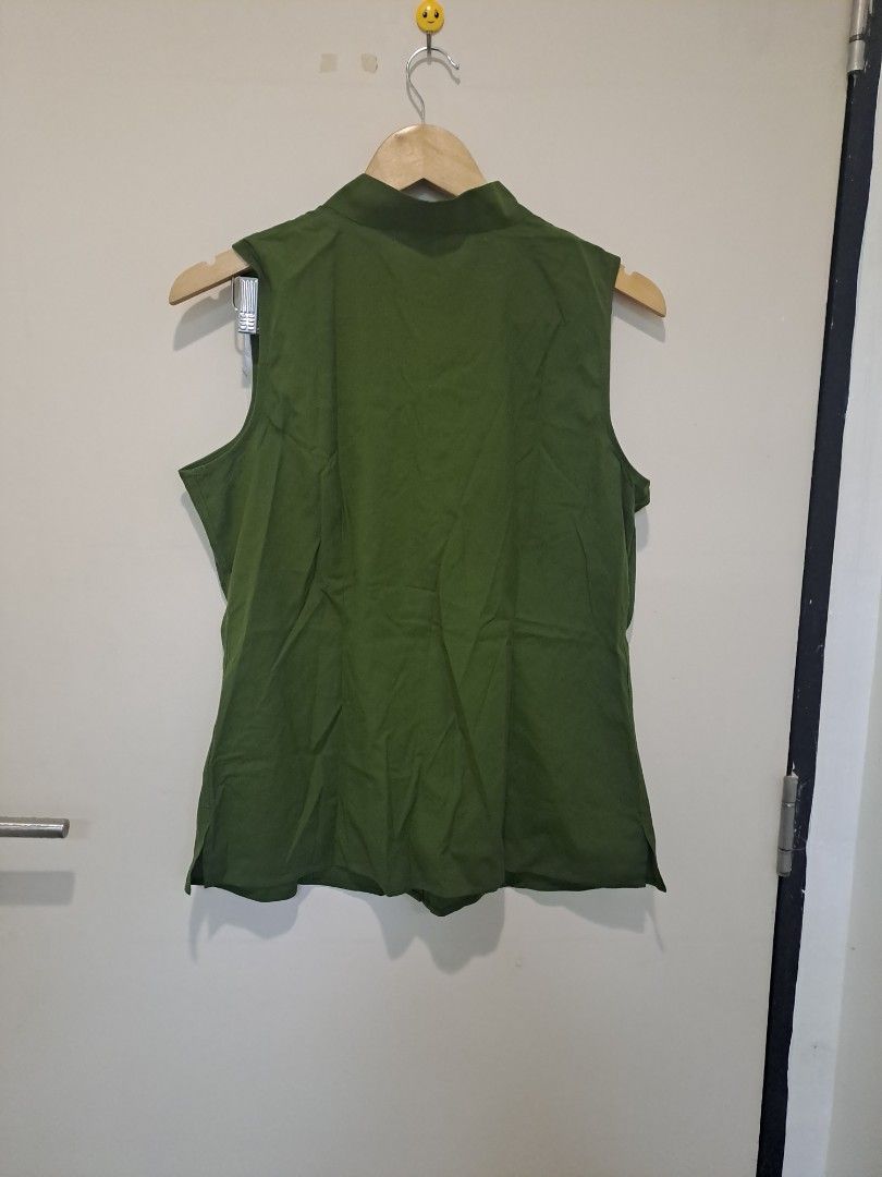 Talbots olive green sleeveless (Category: Sleeveless) located in Manila. Submitted by joanbalde39643 (Listing ID 1470711326, Image 3). Description: This item is a Talbots olive green sleeveless top featuring a distinctive standing asymmetric collar. It features a hidden placket with an off-center top button detail and clean, minimal armholes, blending utilitarian tailoring with an elegant modern silhouette..