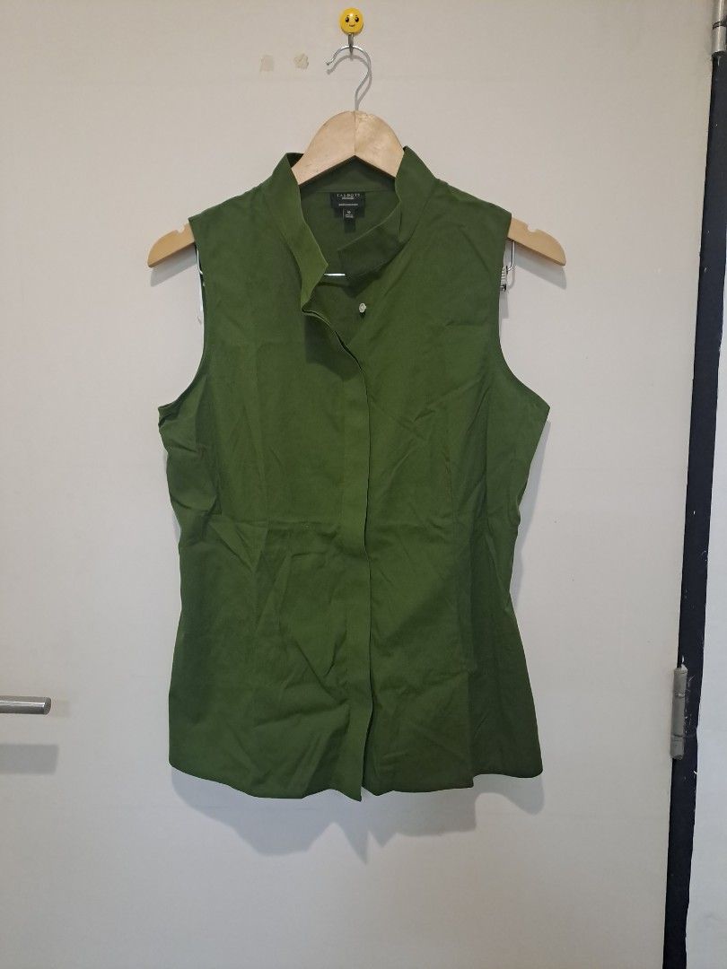 Talbots olive green sleeveless (Category: Sleeveless) located in Manila. Submitted by joanbalde39643 (Listing ID 1470711326, Image 1). Description: This item is a Talbots olive green sleeveless top featuring a distinctive standing asymmetric collar. It features a hidden placket with an off-center top button detail and clean, minimal armholes, blending utilitarian tailoring with an elegant modern silhouette..