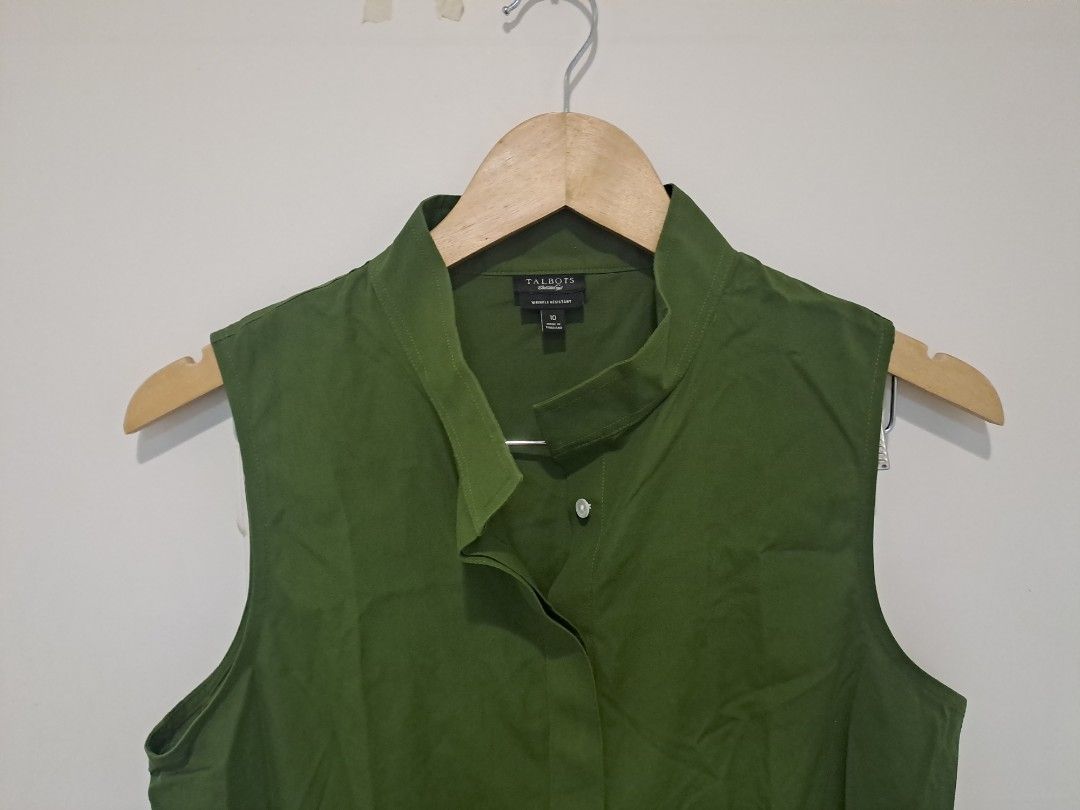 Talbots olive green sleeveless (Category: Sleeveless) located in Manila. Submitted by joanbalde39643 (Listing ID 1470711326, Image 2). Description: This item is a Talbots olive green sleeveless top featuring a distinctive standing asymmetric collar. It features a hidden placket with an off-center top button detail and clean, minimal armholes, blending utilitarian tailoring with an elegant modern silhouette..