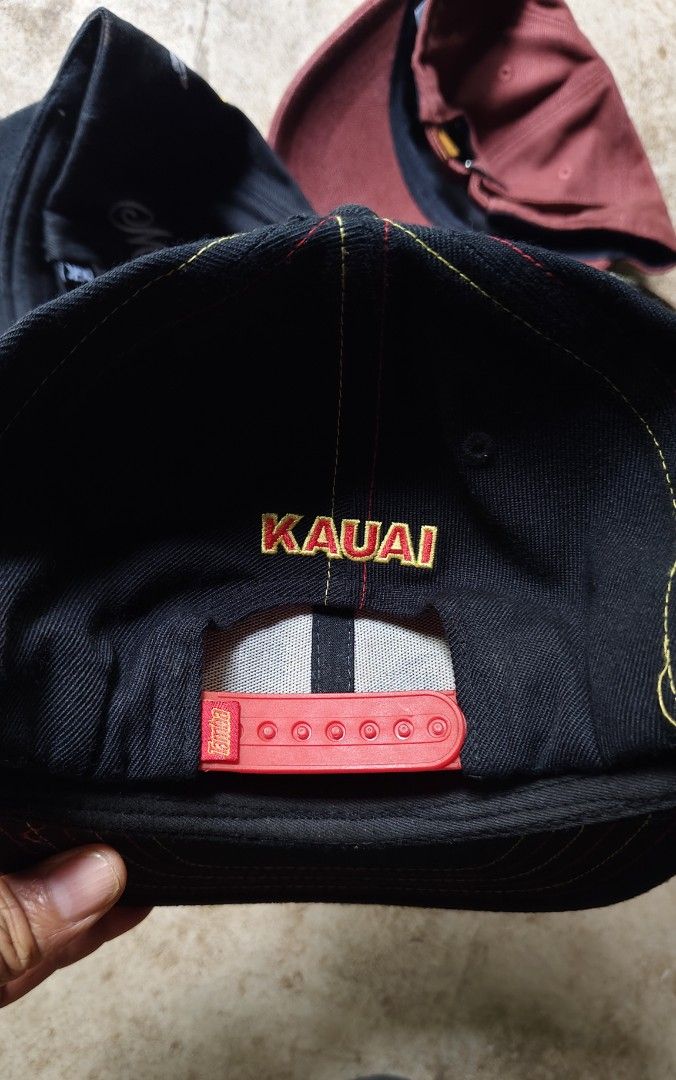 Tamba Surf Co Kauai Snapback Hat (Category: Caps & Hats) located in Quezon City. Submitted by truedeer_cda94c (Listing ID 1470605291, Image 2). Description: - Brand: Tamba Surf Co Kauai - Style: Black snapback hat with red plastic closure - Design: Eye-catching red and yellow embroidery on front and back - Material: Premium acrylic, wool, and PU spandex blend - Condition: Clean structure with solid stitching.