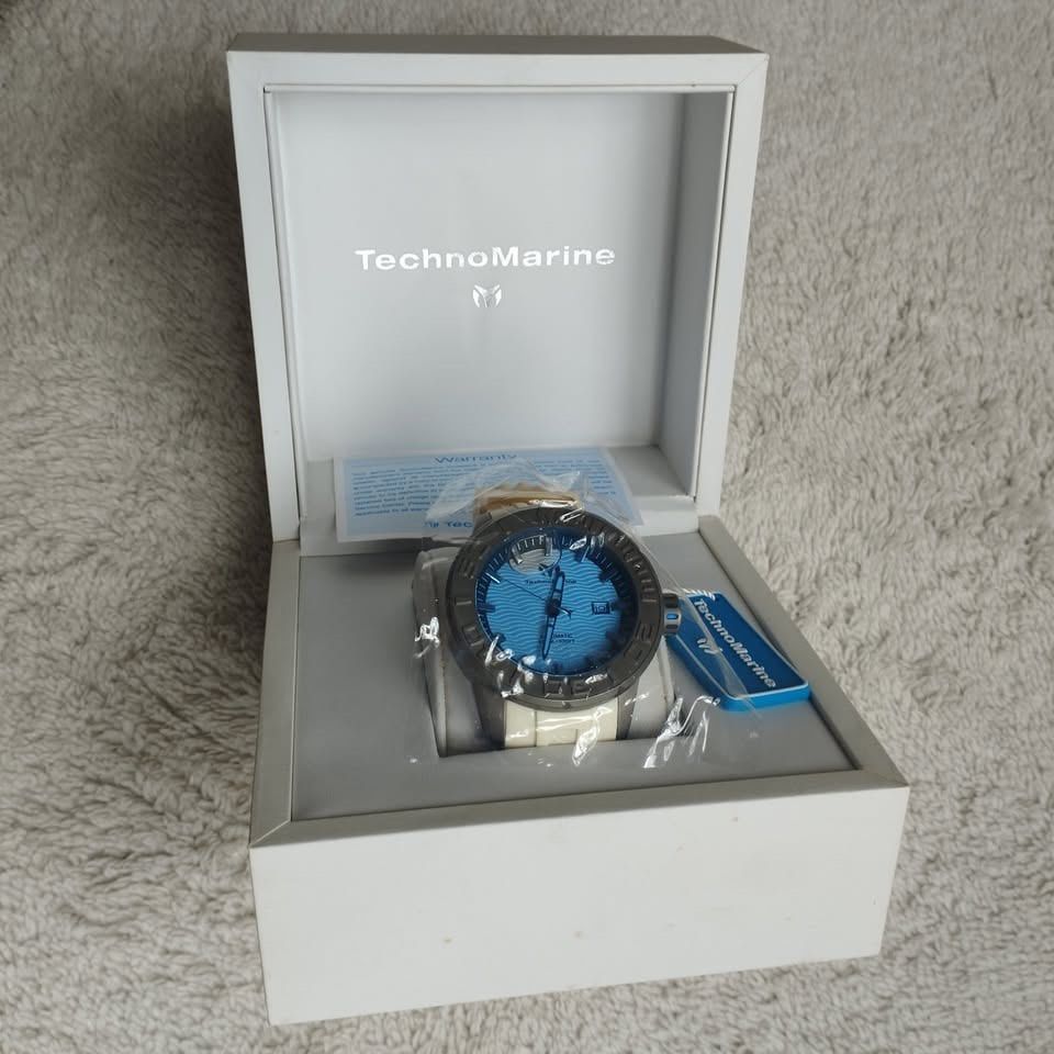TechnoMarine Automatic Watch with Box and Warranty (Category: Luxury Watches) located in Manila. Submitted by manimtim.joy (Listing ID 1470586624, Image 2). Description: - Brand: TechnoMarine Automatic Watch - Dial: Bright blue with a stylish wave pattern - Bezel & Strap: Dark bezel paired with a clean white strap - Condition: Brand new and unused, still in original protective plastic - Inclusions: Original white branded presentation box, warrant