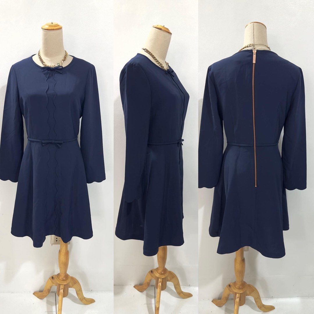Ted Baker Navy Blue Scallop Bow Dress Size 2 (Category: Dresses) located in Bacolod City. Submitted by bhabissagal-05763 (Listing ID 1470656201, Image 2). Description: - Brand: Ted Baker - Color: Navy Blue - Size: 2 (UK 10 / US 4-6) - Style: Skater dress with long sleeves and crew neckline - Details: Delicate front bow, vertical scalloped piping, and scalloped cuffs - Hardware: Exposed rose gold back zipper - Accessories: Includes matching skinny