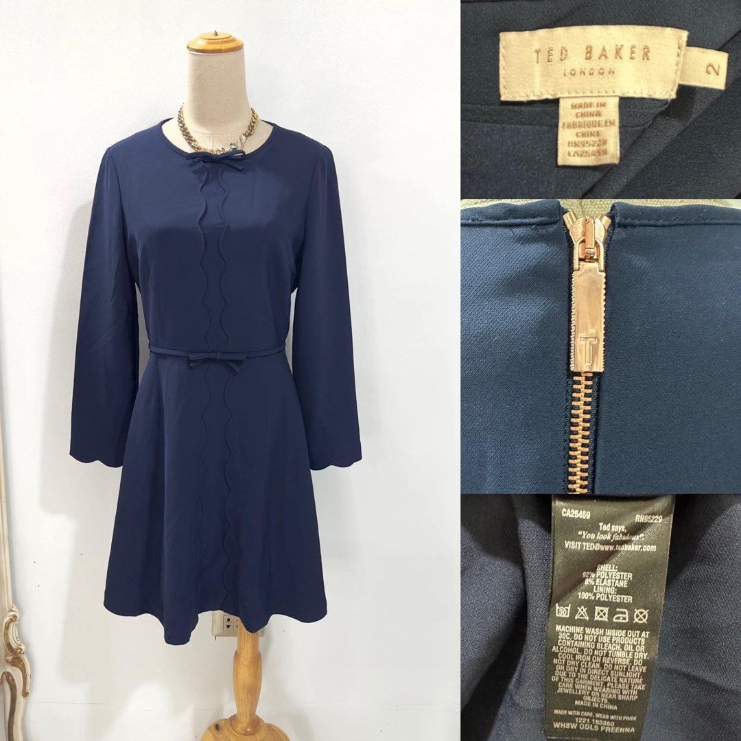 Ted Baker Navy Blue Scallop Bow Dress Size 2 (Category: Dresses) located in Bacolod City. Submitted by bhabissagal-05763 (Listing ID 1470656201, Image 1). Description: - Brand: Ted Baker - Color: Navy Blue - Size: 2 (UK 10 / US 4-6) - Style: Skater dress with long sleeves and crew neckline - Details: Delicate front bow, vertical scalloped piping, and scalloped cuffs - Hardware: Exposed rose gold back zipper - Accessories: Includes matching skinny