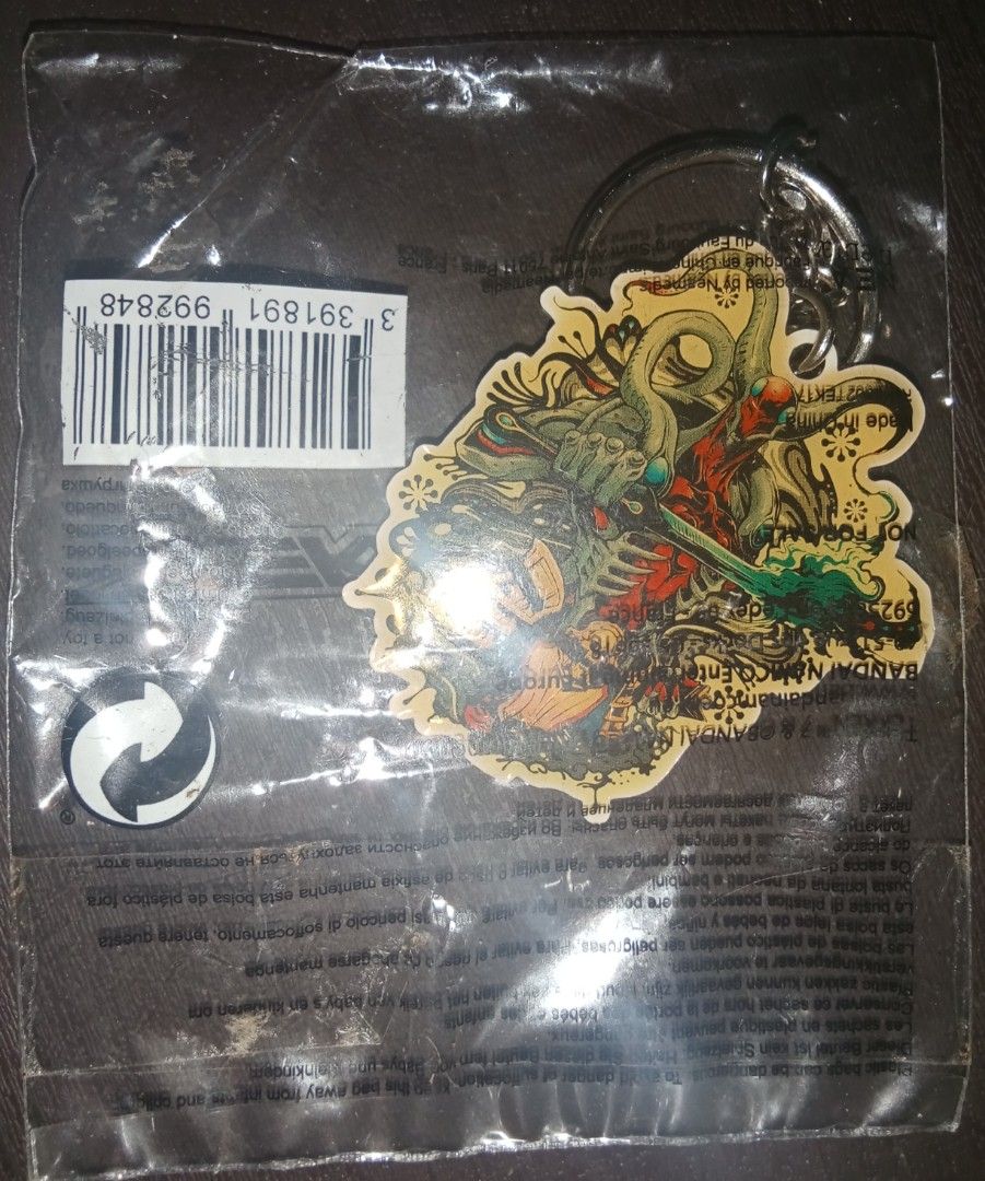 Tekken 7 Yoshimitsu Official Keychain (Category: Character Goods) located in Cavite. Submitted by emilgarcia09 (Listing ID 1470729535, Image 1). Description: - Official Bandai Namco Tekken 7 merchandise - Character: Yoshimitsu - Condition: Brand new, still sealed in original plastic packaging with barcode sticker - Design: Detailed artwork on the front with classic logo on the reverse - Hardware: Includes metal split ring, ready for keys or bags.