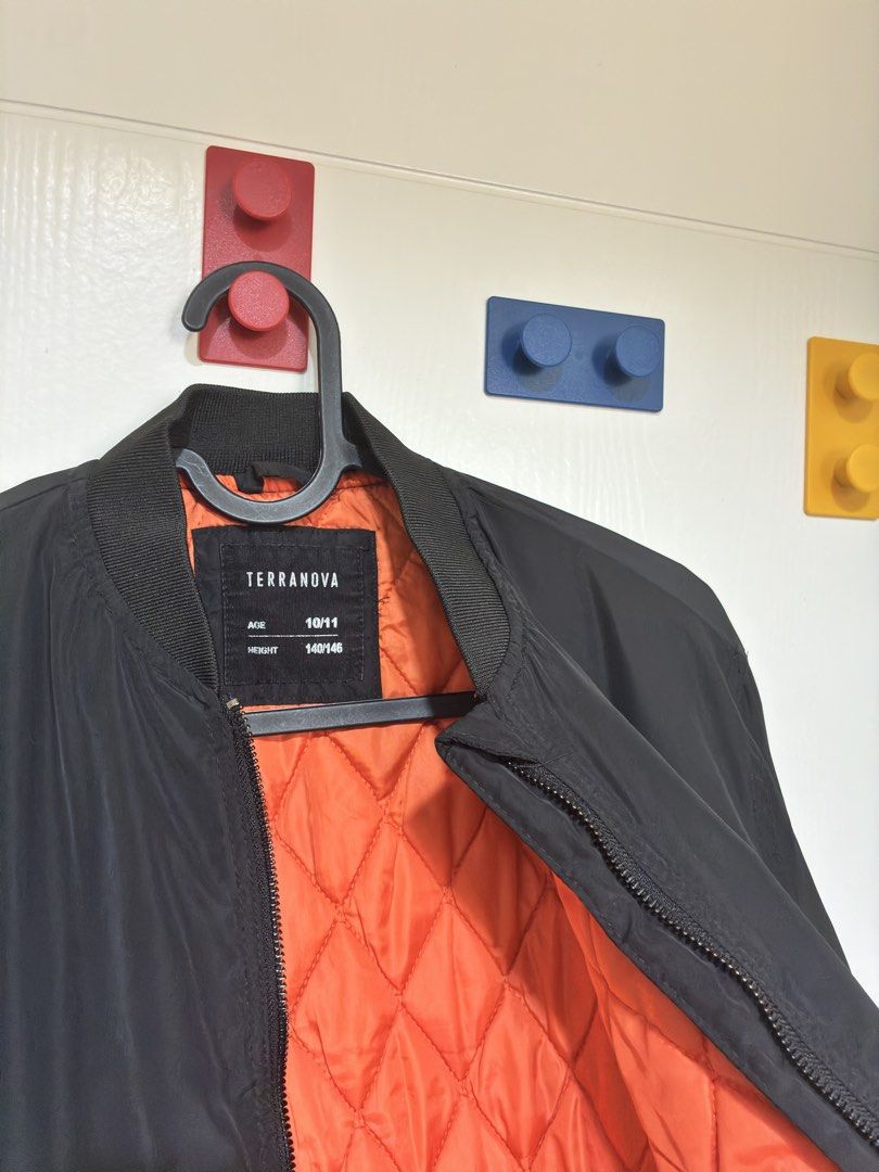 Terranova Black Bomber Jacket Age 10/11 140/146 (Category: Coats, Jackets and Outerwear) located in Mandaluyong City. Submitted by littlecatstore (Listing ID 1470632876, Image 2). Description: - Brand: Terranova - Item: Black bomber jacket with bright orange quilted lining - Size: Age 10/11 years (Height 140/146 cm) - Features: Zip-up front, zipped side pockets, sleeve utility pocket, and ribbed collar, cuffs, and hem.