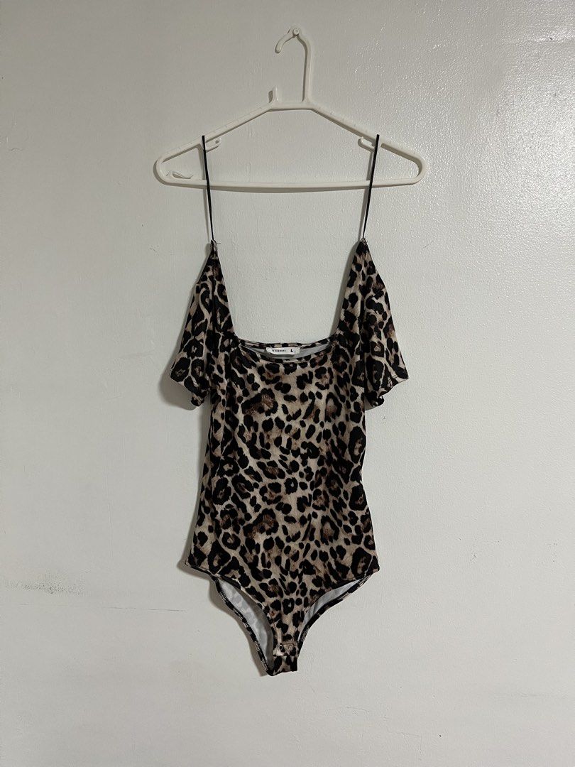 Terranova Leopard Print Bodysuit (Category: Bikinis & Swimsuits) located in Cabuyao City. Submitted by rdtrmt (Listing ID 1470573612, Image 1). Description: - Brand: Terranova - Size: Large - Print: Bold leopard print - Design: Square neckline, thin black spaghetti straps, and short draped cold-shoulder sleeves - Closure: Convenient snap closure at the bottom - Fit: Stretchy, comfortable, and easy to wear - Condition: still in good condition .