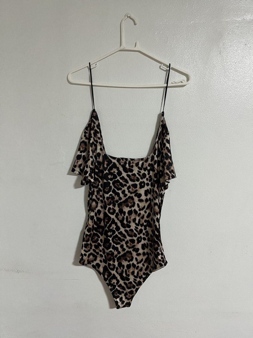 Terranova Leopard Print Bodysuit (Category: Bikinis & Swimsuits) located in Cabuyao City. Submitted by rdtrmt (Listing ID 1470573612, Image 3). Description: - Brand: Terranova - Size: Large - Print: Bold leopard print - Design: Square neckline, thin black spaghetti straps, and short draped cold-shoulder sleeves - Closure: Convenient snap closure at the bottom - Fit: Stretchy, comfortable, and easy to wear - Condition: still in good condition .
