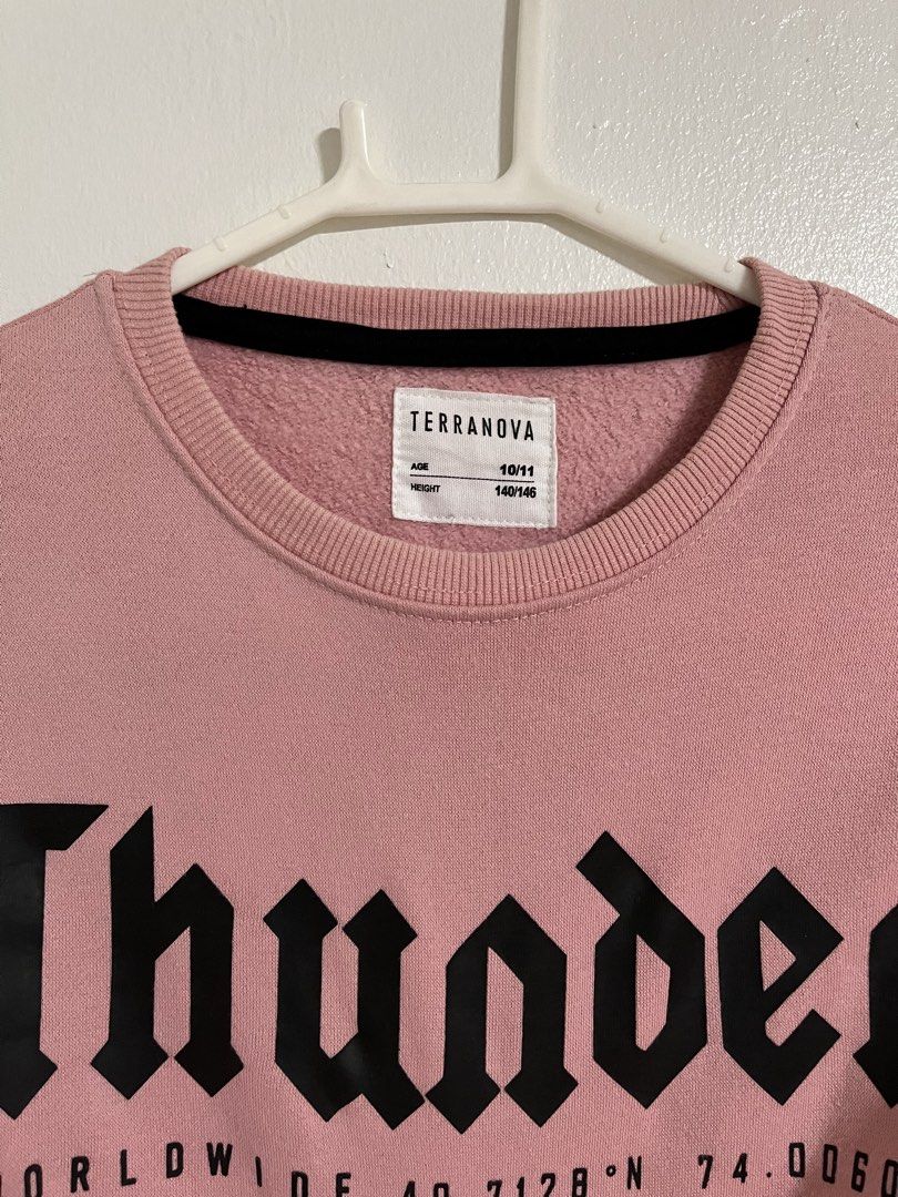 Terranova Pink Thunder Graphic Sweatshirt (Category: Babies & Kids Fashion) located in Cabuyao City. Submitted by rdtrmt (Listing ID 1470565728, Image 2). Description: - Brand: Terranova - Color: Pink - Size: 10/11 years (Height 140/146 cm) - Design: Black 'Thunder' text with coordinates on the front, small patch label near the back collar - Details: Crew neckline, ribbed cuffs and hem - Material: Soft cotton blend - Ideal for: Great casual piece