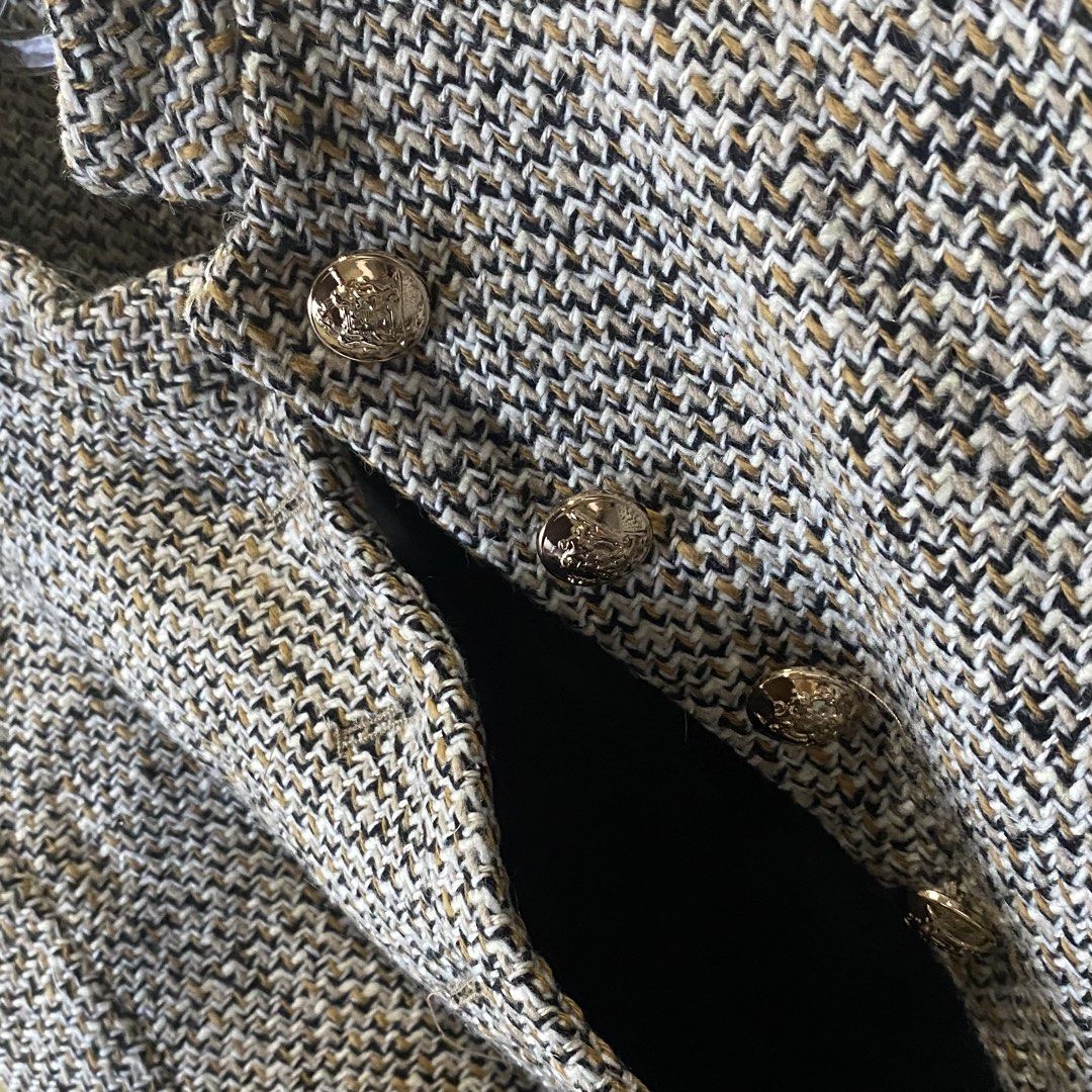Textured tweed jacket with embossed gold buttons (Category: Coats, Jackets and Outerwear) located in Marikina City. Submitted by lovegoeson (Listing ID 1470724693, Image 2). Description: - Style: Chic tweed jacket in a black, white, and tan weave - Design: Stand collar, structured shoulders, and cropped cut - Details: Ornate gold metallic buttons on the front placket and cuffs - Comfort: Fully lined interior for a smooth fit.