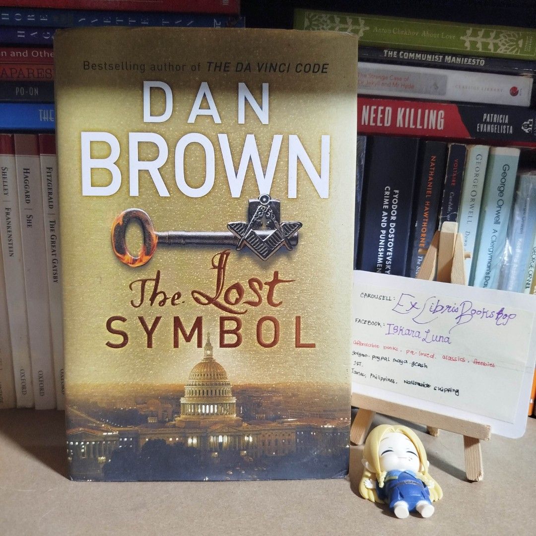 The Lost Symbol by Dan Brown Novel Paperback (Category: Storybooks) located in Tarlac. Submitted by exlibrisbookshop (Listing ID 1470729363, Image 1). Description: - Title: The Lost Symbol by Dan Brown - Genre: Thriller / Mystery - Plot: Follow Robert Langdon in a fast-paced hunt through Washington D.C. filled with hidden codes and Masonic secrets - Format: Standard paperback - Condition: Spine intact and pages clean, great for reading.