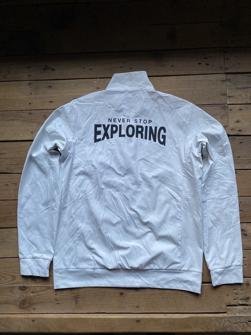 The North Face Never Stop Exploring White Track Jacket (Category: Coats, Jackets and Outerwear) located in Manila. Submitted by bravefox-98f5 (Listing ID 1470688732, Image 1). Description: - Brand: The North Face - Color: White with small black chest logo - Size: 160 (Youth/Petite friendly) - Design: Full zip, stand collar, and striking 'Never Stop Exploring' back lettering - Storage: Two secure front zip pockets - Fit: Ribbed cuffs and hem with 