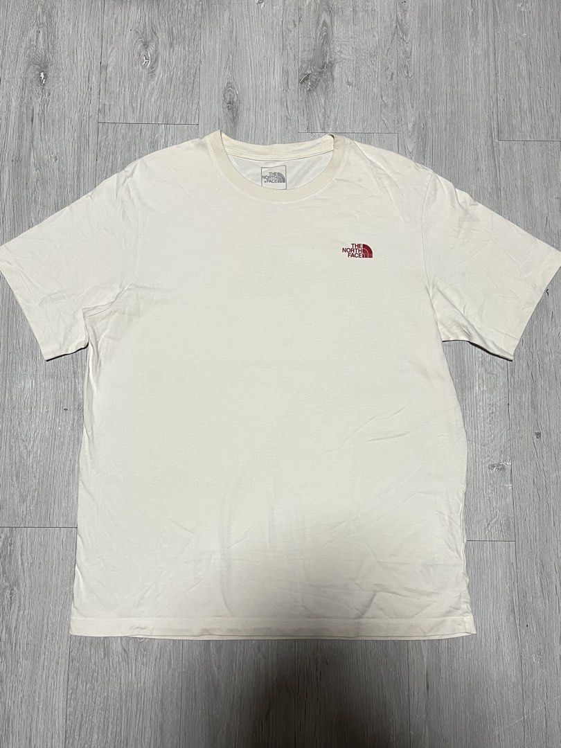 The North Face Never Stop Exploring Graphic T-Shirt (Category: Tshirts & Polo Shirts ) located in Manila. Submitted by jorgemabelin2001 (Listing ID 1470697955, Image 1). Description: - Brand: The North Face - Color: Off-white - Material: 100% Cotton - Design: Small red chest logo, large geometric tent graphic and 'Never Stop Exploring' text on the back - Size: Men US L / Asia XL | Women US XL / Asia 2XL - Made in: China - Flaws: Noticeable yellow