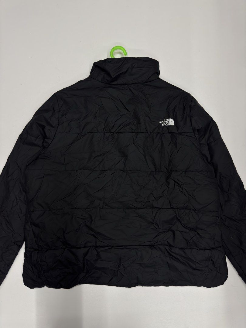 The North Face x Swire Coca-Cola Puffer Jacket (Category: Coats, Jackets and Outerwear) located in Bustos. Submitted by thenlnclot60500 (Listing ID 1470639979, Image 2). Description: - Brand: The North Face - Style: Lightweight quilted puffer jacket with stand collar and full zip front - Color: Black - Size: Women's XXL - Material: 100% polyester (shell, lining, filling) - Special Feature: Swire Coca-Cola embroidery on the chest - Condition: Clea
