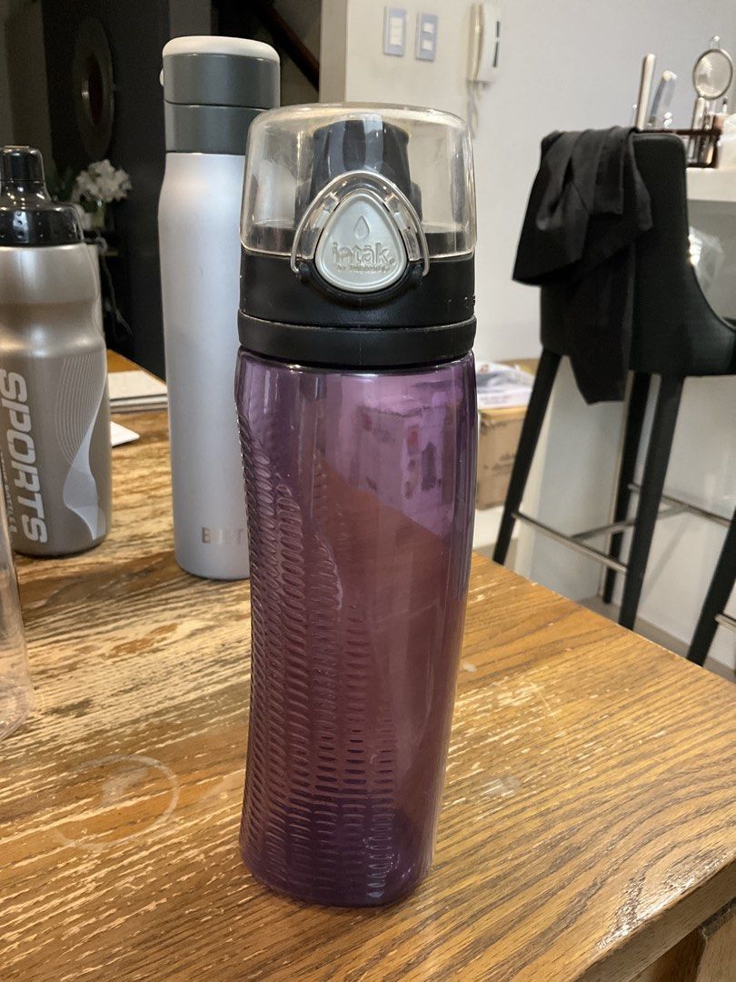 Thermos Intak Purple Water Bottle (Category: Water Bottles & Tumblers) located in Manila. Submitted by momfinds.mnl (Listing ID 1470619143, Image 1). Description: - Brand/Model: Thermos Intak Water Bottle - Color: Vibrant purple with a black lid and clear protective cap - Features: Textured grip section for easy handling - Condition: Clean overall body; minor yellowish staining and buildup on the underside of the lid stopper - Best for: Gym worko